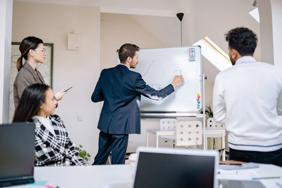 Focused business analysis with charts and graphs on a laptop in a modern office setting.